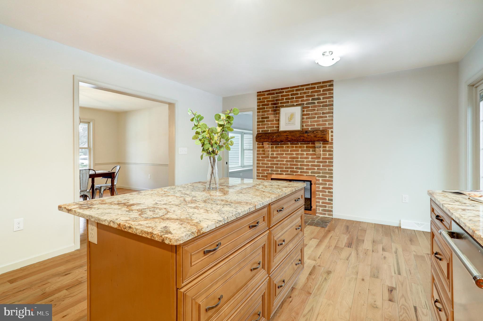 152 Kings Gate Drive Lititz, PA 17543 - Photo 15 of 45 a room with kitchen island a sink a stove and a wooden floors