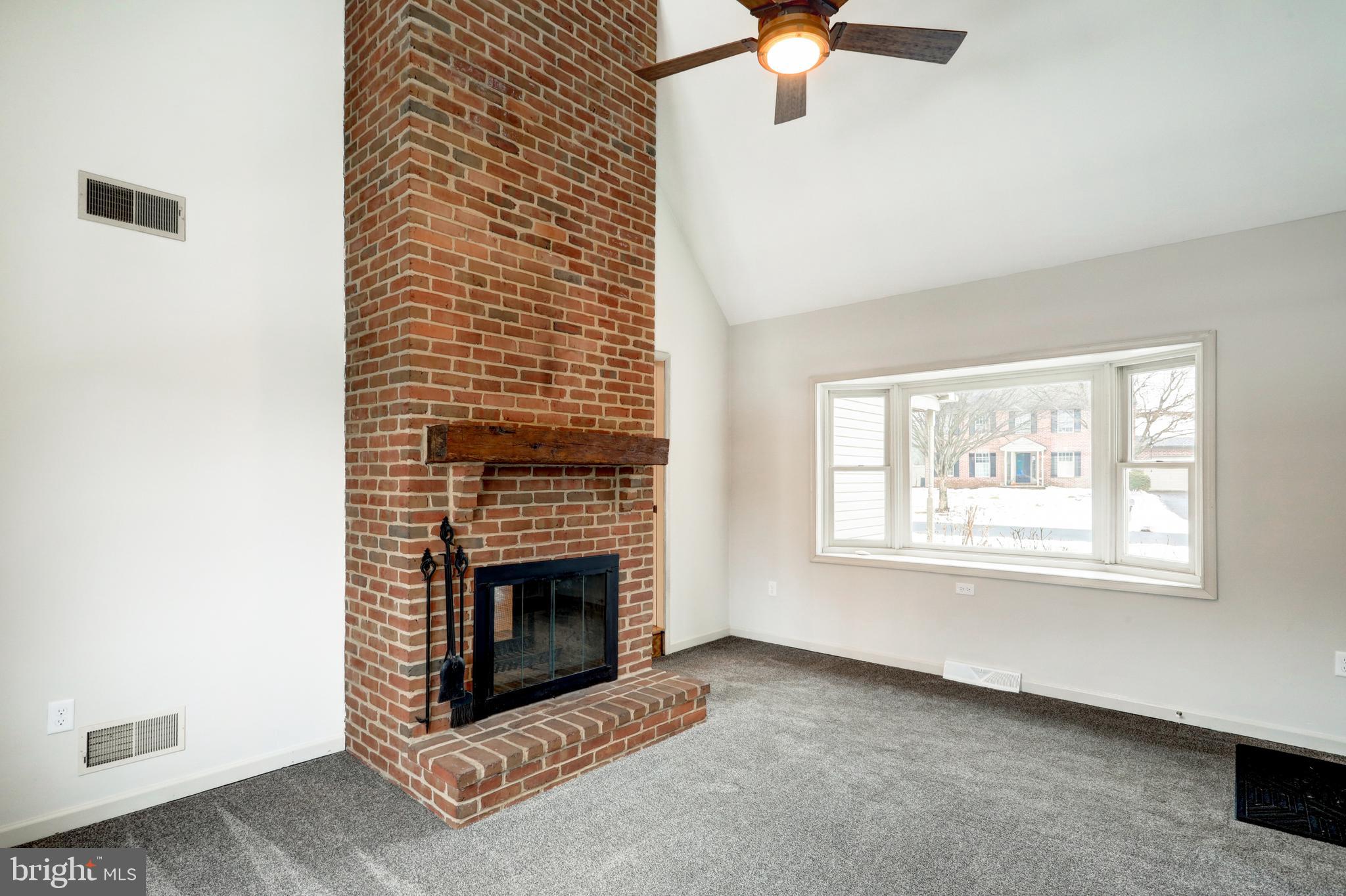 152 Kings Gate Drive Lititz, PA 17543 - Photo 19 of 45 an empty room with windows and fireplace