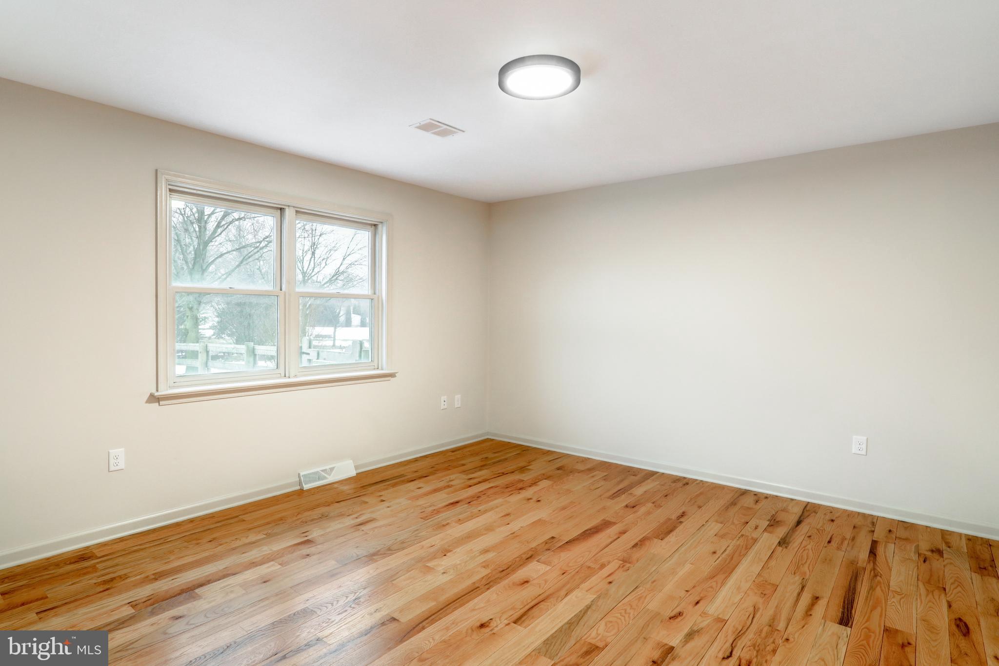 152 Kings Gate Drive Lititz, PA 17543 - Photo 21 of 45 an empty room with wooden floor and windows