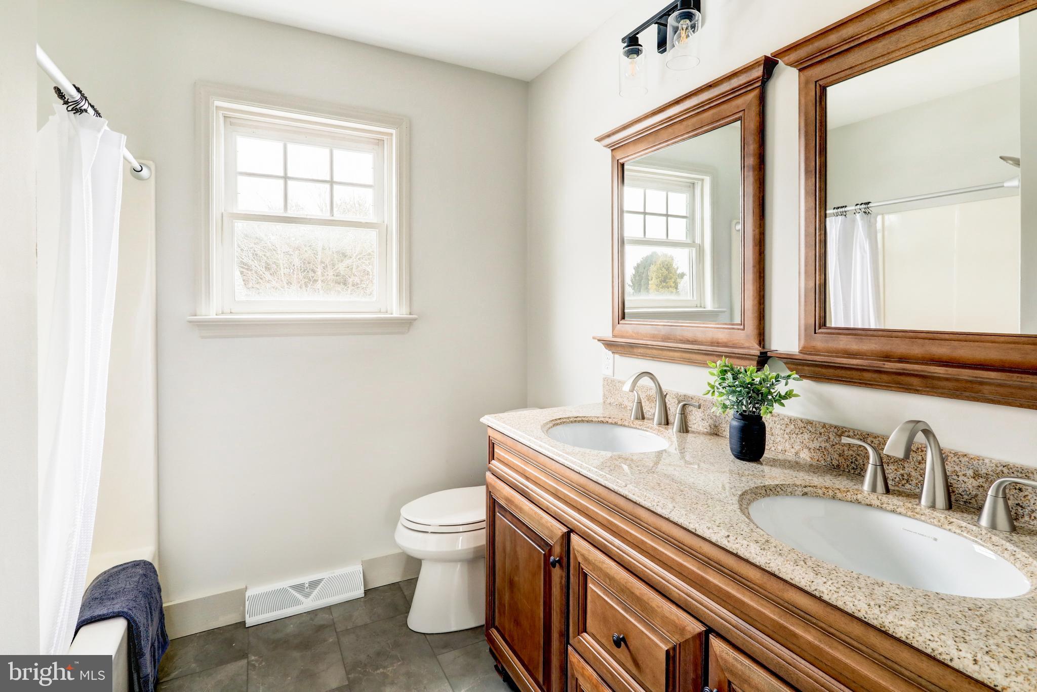 152 Kings Gate Drive Lititz, PA 17543 - Photo 28 of 45 a bathroom with a granite countertop sink a toilet and a window