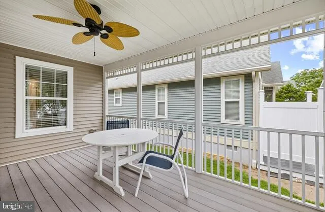a view of a chair and tables in the balcony
