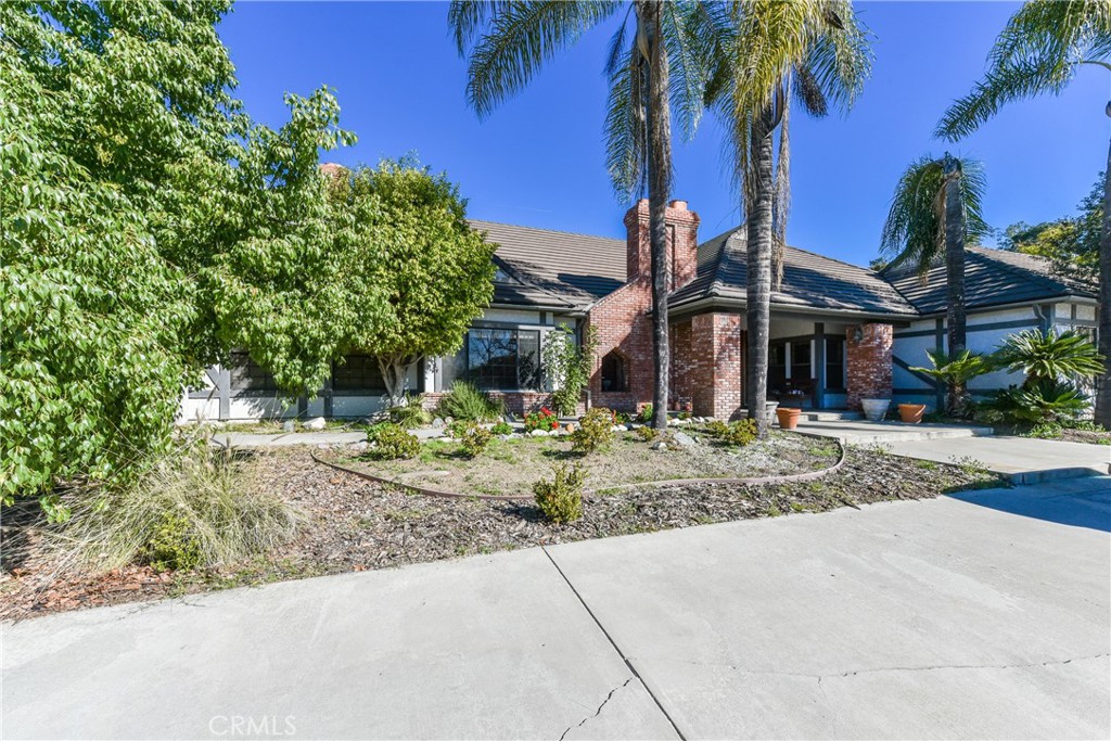 99 Bliss Canyon Road Bradbury, CA 91008 - Photo 11 of 49 a view of a house with palm tree and a small yard