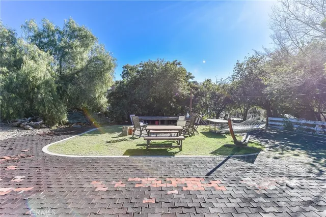 a view of backyard with swimming pool and outdoor seating