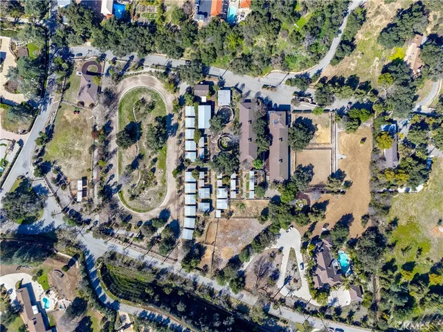 an aerial view of a multi story building with outdoor space and trees
