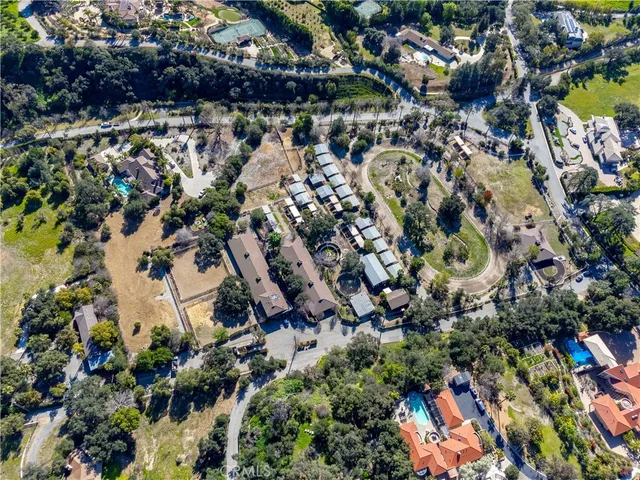 an aerial view of residential houses with swimming pool and outdoor space