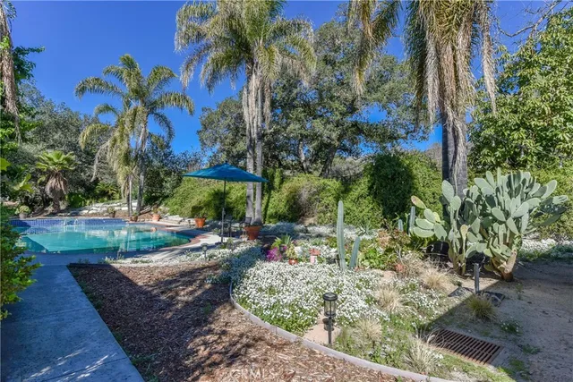 a view of a house with swimming pool and sitting area