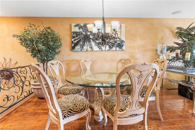 a view of a dining room with furniture a chandelier and wooden floor