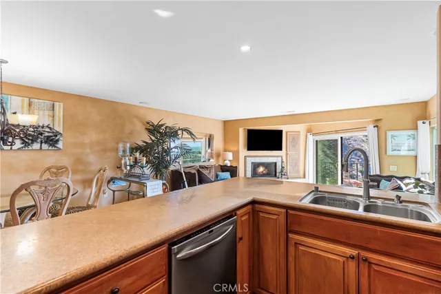 a kitchen with counter top space and living room