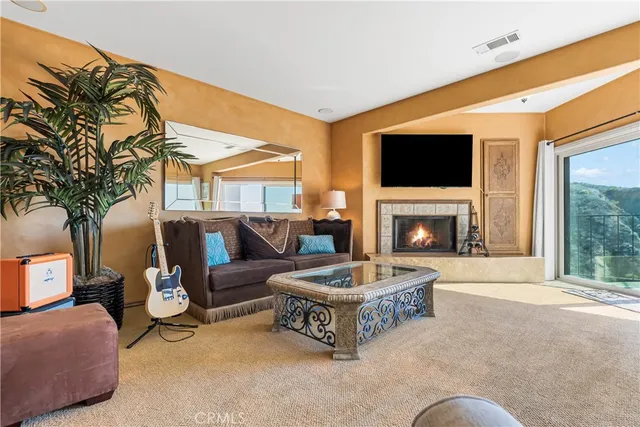 a living room with fireplace furniture and a flat screen tv