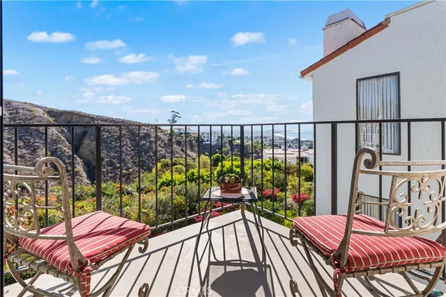 a bed sitting in a bedroom next to a lamp with a desk and a window