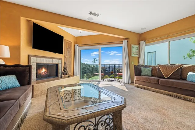 a living room with fireplace furniture and a flat screen tv