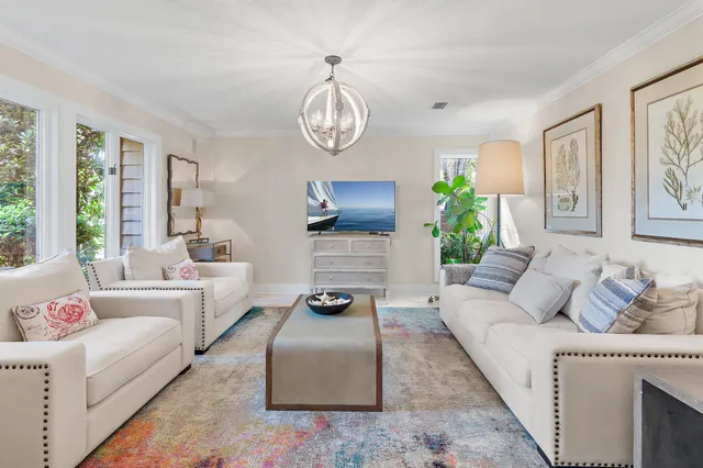 a living room with furniture a fireplace and a large window