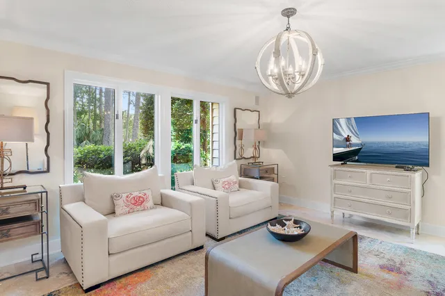 a living room with furniture and view of kitchen