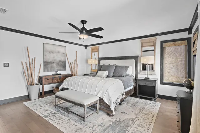 a bedroom with a large bed and a chandelier