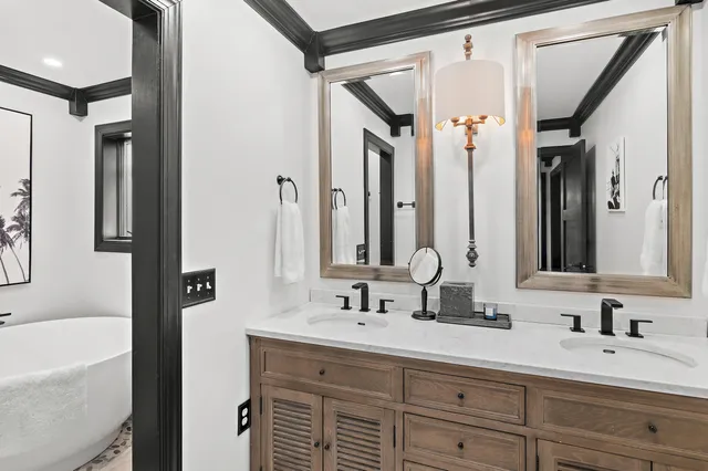a bathroom with a sink a toilet a mirror and shower