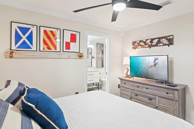 a spacious bedroom with a bed and a painting on the wall