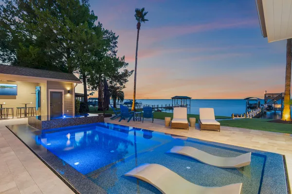 a swimming pool with outdoor seating and yard