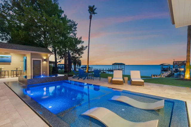 a swimming pool with outdoor seating and yard