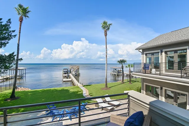 a bathroom with a granite countertop sink a mirror and shower