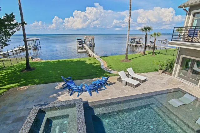 a spacious bedroom with a large bed and a large window