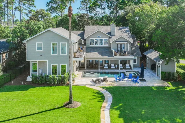 a front view of a house with a yard and trees