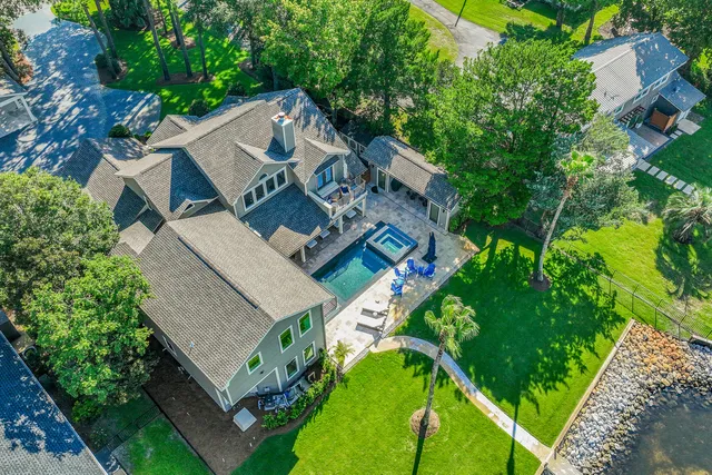 a living room with furniture chandelier and a flat screen tv