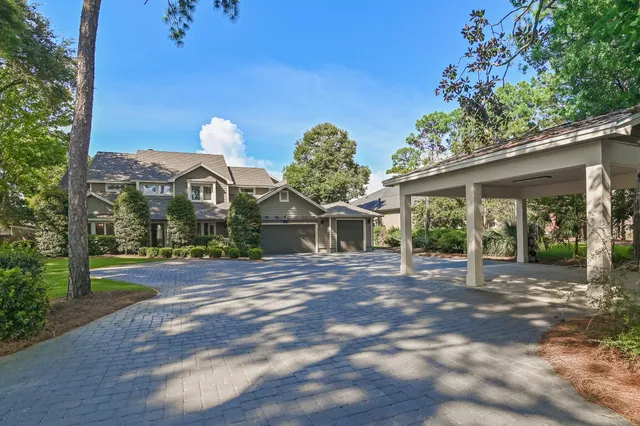 a living room with furniture a flat screen tv and a window