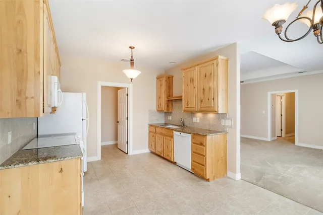 a kitchen with stainless steel appliances granite countertop a stove and a refrigerator