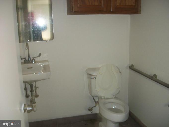 2409 Cool Spring Road Adelphi, MD 20783 - Photo 6 of 24 a white toilet sitting next to a bathroom sink