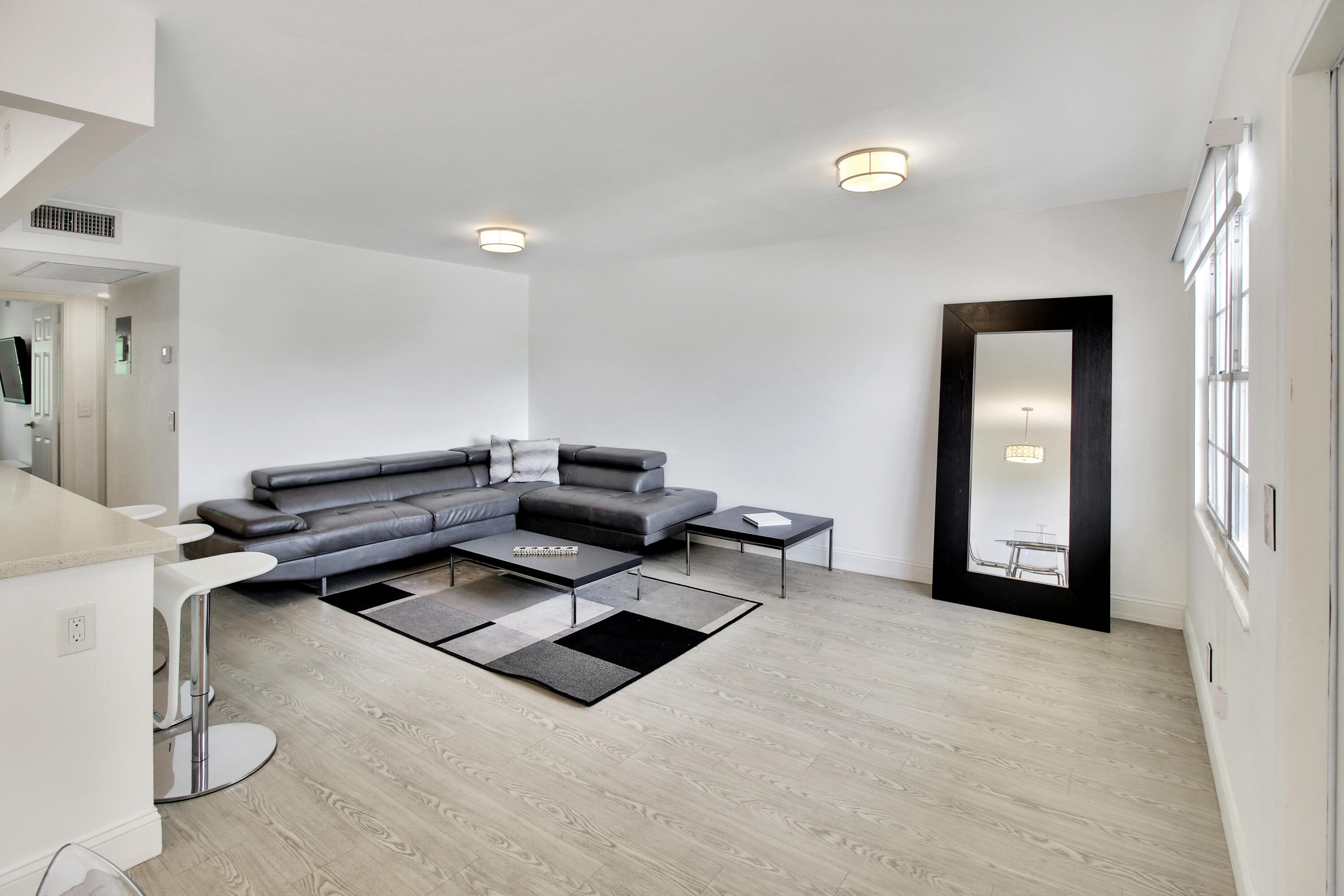 17 Fanshaw A Boca Raton, FL 33434 - Photo 2 of 11 a living room with furniture a rug and white walls