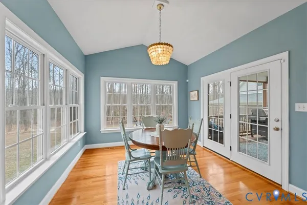 a view of a dining room with a table and chairs