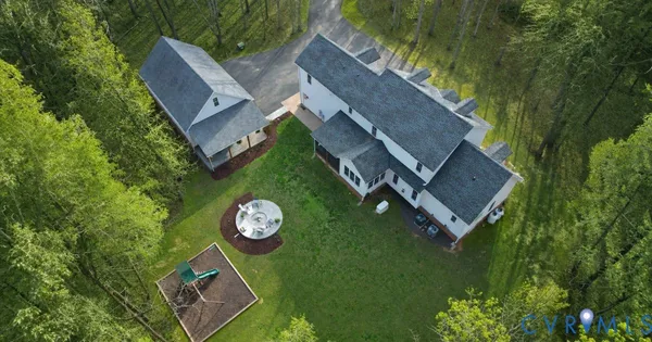 a view of a kitchen with granite countertop a stove top oven a sink dishwasher a dining table and chairs with wooden floor