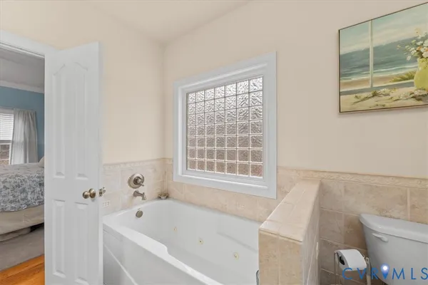 a bathroom with a toilet a sink and a window