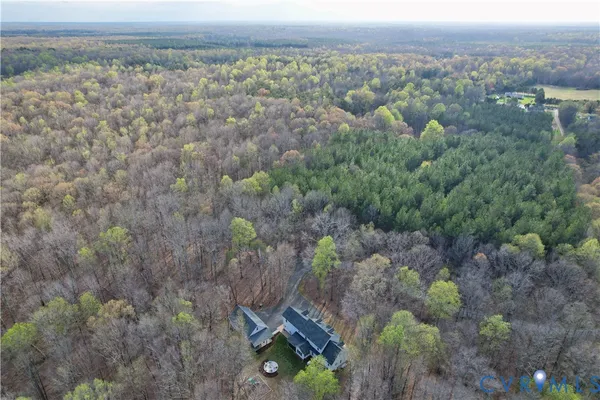 a view of a livingroom with wooden floor and stairs