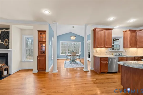 a kitchen with a refrigerator a sink dishwasher with a dining table and chairs