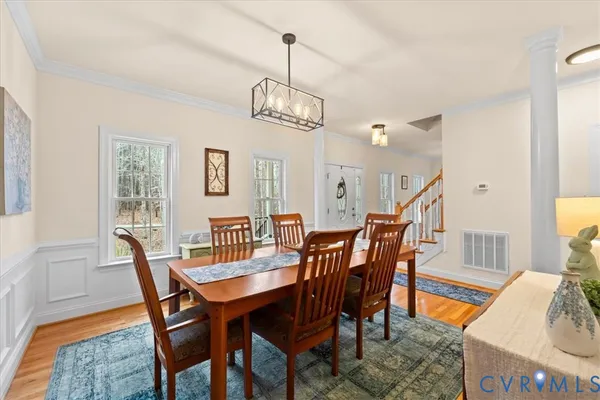 a view of a dining room with a table and chairs