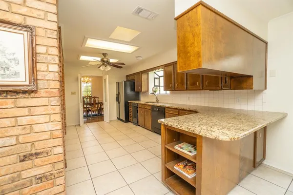 a kitchen with a sink a stove and cabinets