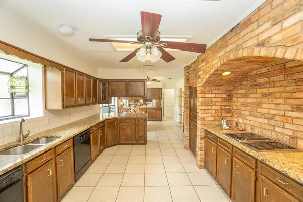a large kitchen with stainless steel appliances a sink dishwasher stove and refrigerator