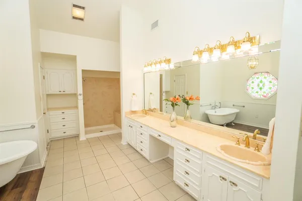 a spacious bathroom with a double vanity sink mirror and