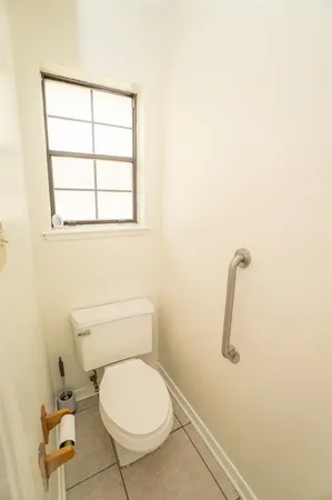 a white toilet sitting next to a window