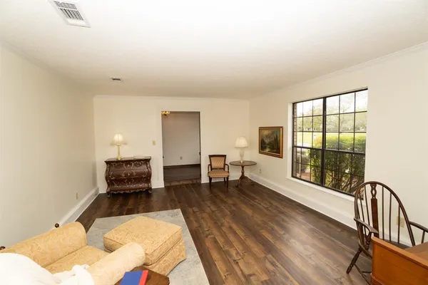 a living room with furniture lamp and large window