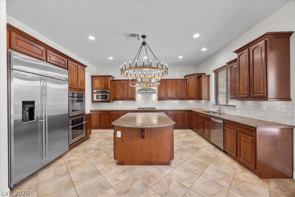 2125 De Rouge Avenue Henderson, NV 89044 - Photo 2 of 96 Culinary aspirations come alive in this kitchen, featuring an oversized island, ample cabinetry, and sleek appliances.