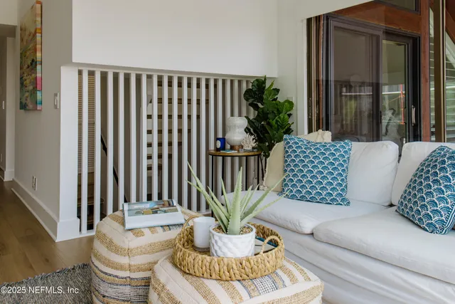 a living room with furniture and a potted plant