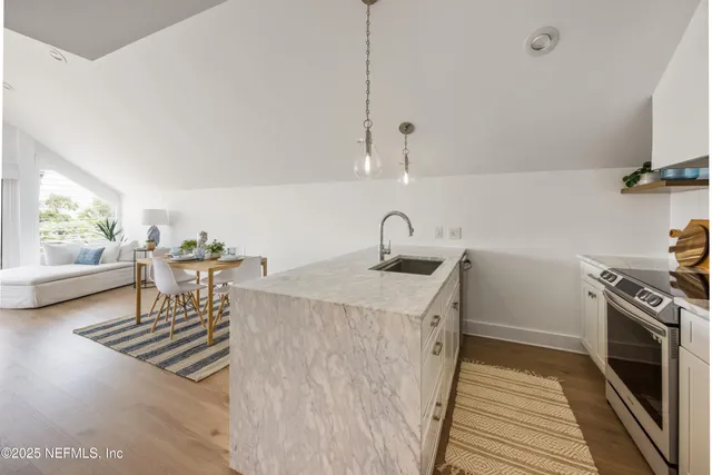 a kitchen with a sink and a stove top oven