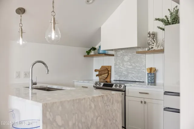 a kitchen with a sink and a stove