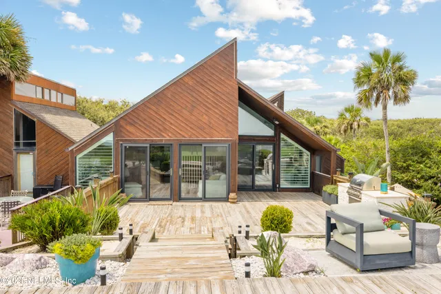 a view of a patio with couches table and chairs and potted plants