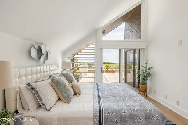 a bedroom with furniture and a large window