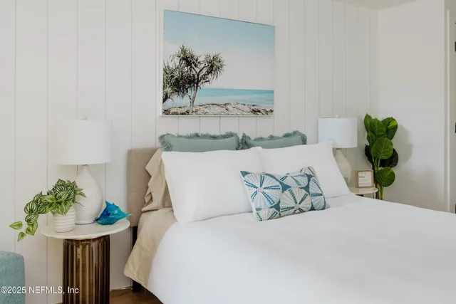 a bed sitting in a bedroom next to a white wall