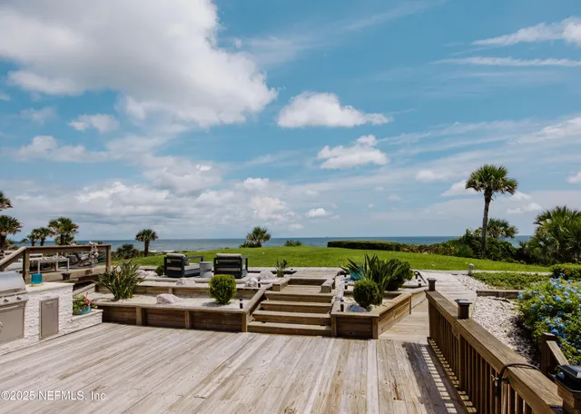 a view of a terrace with lawn chairs