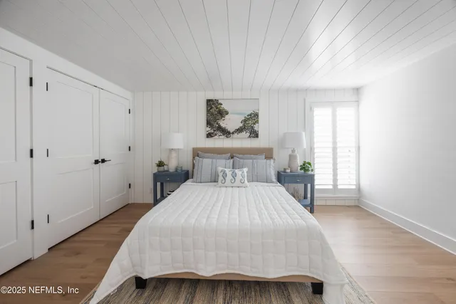 a bedroom with a large bed and a window